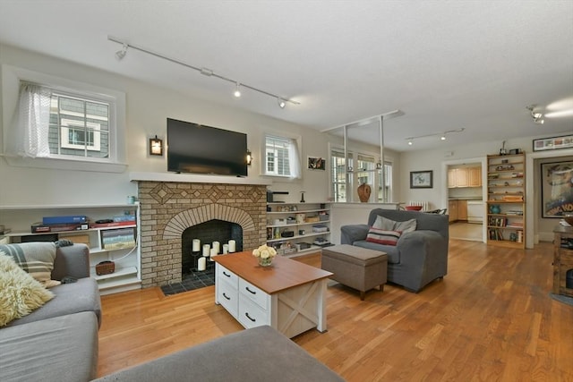 11 Goodway Rd Unit 1, Boston, MA 02130 - living area featuring track lighting, light wood finished floors, and a brick fireplace