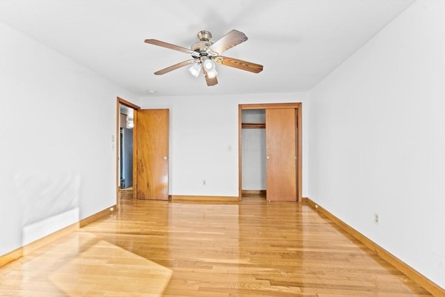 unfurnished bedroom featuring light hardwood / wood-style flooring, a closet, and ceiling fan