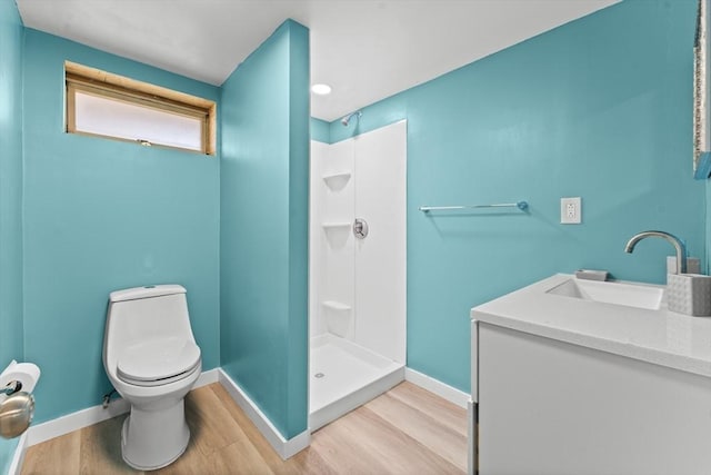 bathroom with vanity, hardwood / wood-style flooring, toilet, and walk in shower