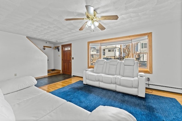 living room featuring wood-type flooring and ceiling fan