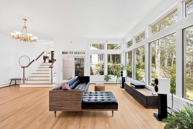 sunroom / solarium featuring a notable chandelier and plenty of natural light