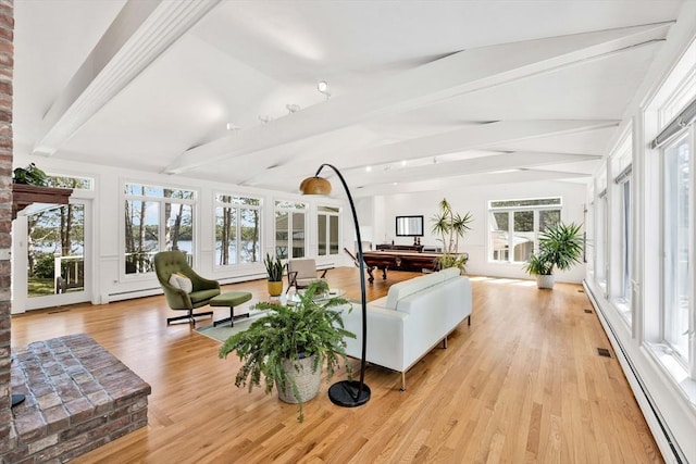 sunroom featuring baseboard heating and vaulted ceiling with beams