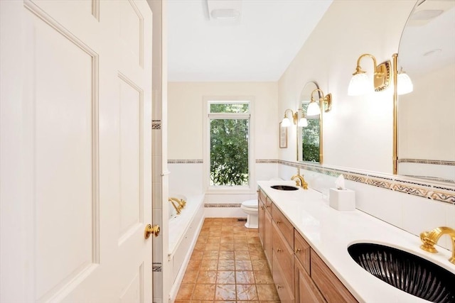 bathroom featuring vanity, a tub, tile walls, and toilet