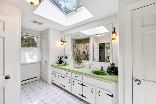 bathroom with vanity, a skylight, a baseboard radiator, and tile patterned floors