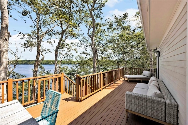 deck with outdoor lounge area and a water view