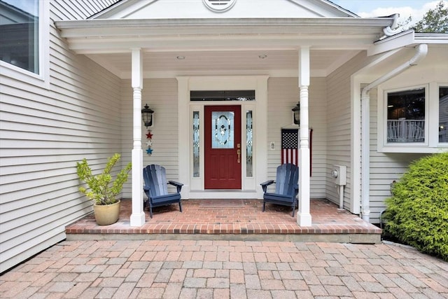 view of exterior entry featuring a porch