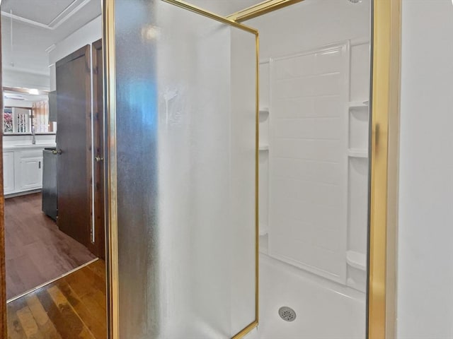 bathroom featuring vanity, a stall shower, and wood finished floors