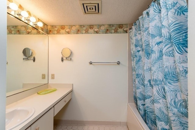 200 Burkhall Unit 103, Weymouth, MA 02190 - bathroom with vanity, a textured ceiling, and shower / bath combo