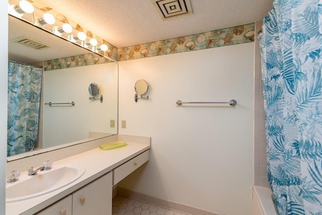 200 Burkhall Unit 103, Weymouth, MA 02190 - full bath featuring vanity, a textured ceiling, shower / bath combination with curtain, and tile patterned flooring