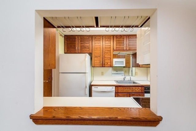 200 Burkhall Unit 103, Weymouth, MA 02190 - kitchen featuring white appliances, brown cabinets, and light countertops
