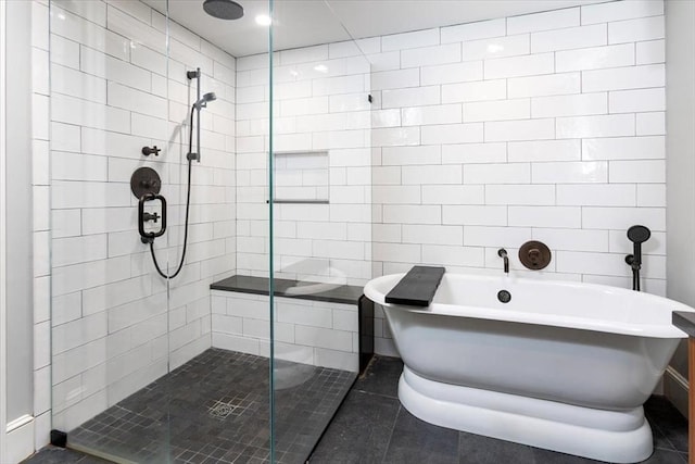 bathroom featuring tile walls and separate shower and tub