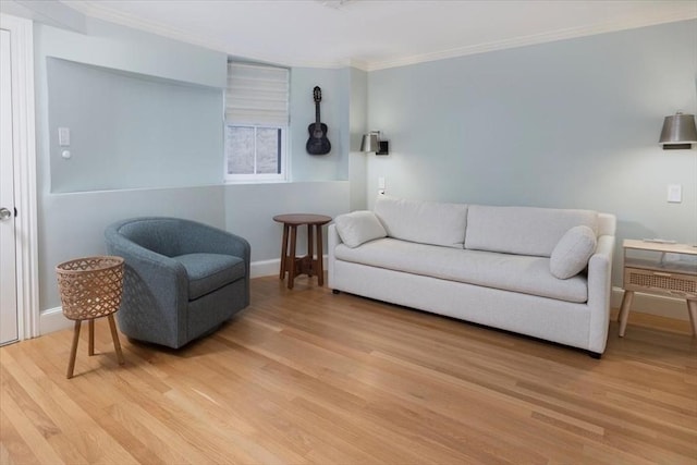 living room with hardwood / wood-style floors and crown molding