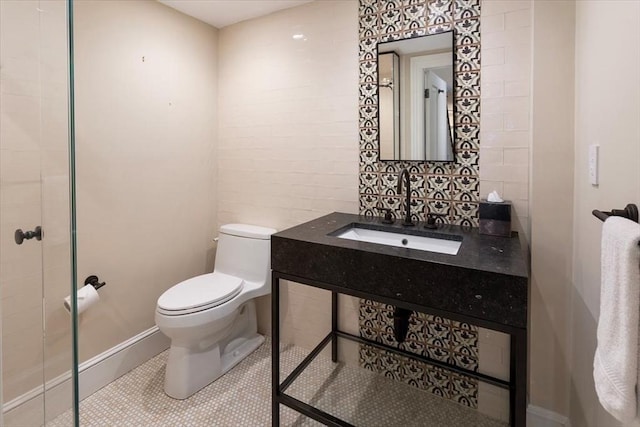 bathroom featuring tile patterned floors, toilet, and sink