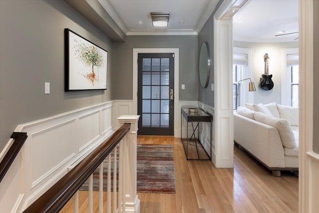 entrance foyer featuring crown molding and light wood-type flooring