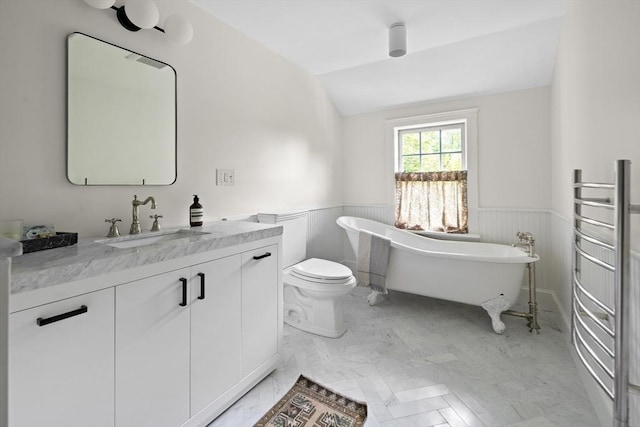 14 Dodges Row, Wenham, MA 01984 - bathroom featuring wainscoting, vanity, a soaking tub, lofted ceiling, and toilet