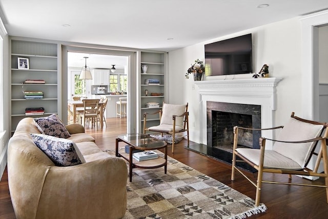 14 Dodges Row, Wenham, MA 01984 - living area with a fireplace with raised hearth, wood finished floors, and built in shelves