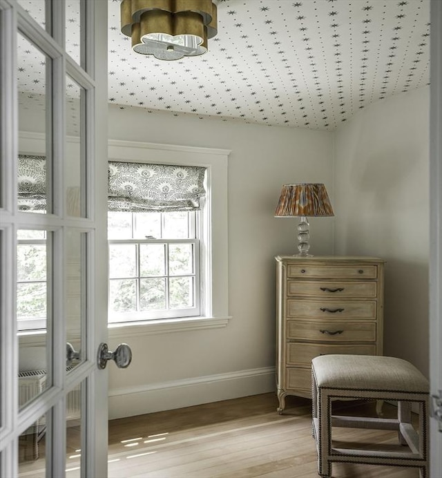 14 Dodges Row, Wenham, MA 01984 - sitting room with light wood finished floors, baseboards, and a chandelier