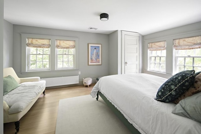14 Dodges Row, Wenham, MA 01984 - bedroom featuring radiator, multiple windows, and wood finished floors