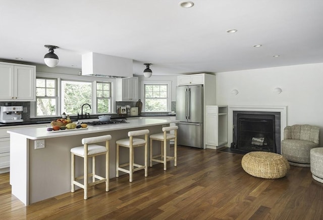 14 Dodges Row, Wenham, MA 01984 - kitchen with high end fridge, tasteful backsplash, a center island, a breakfast bar, and dark wood-style flooring