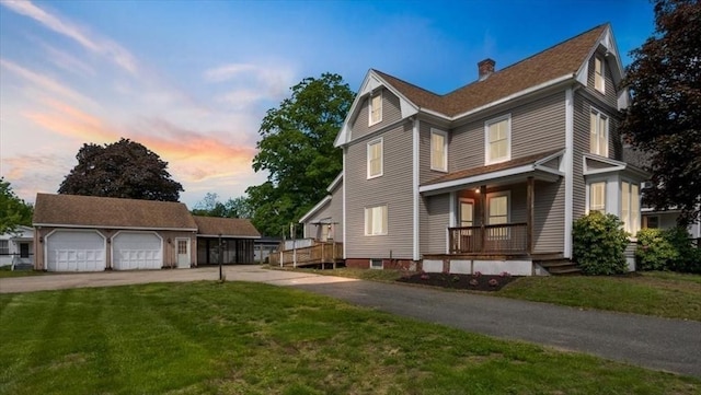 14 Maple St, Amesbury, MA 01913 - view of front of home with covered porch, a chimney, a front yard, and a detached garage