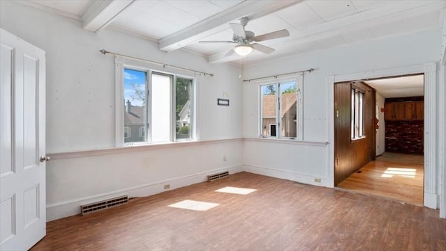 14 Maple St, Amesbury, MA 01913 - empty room featuring wood finished floors, plenty of natural light, beam ceiling, ceiling fan, and baseboards