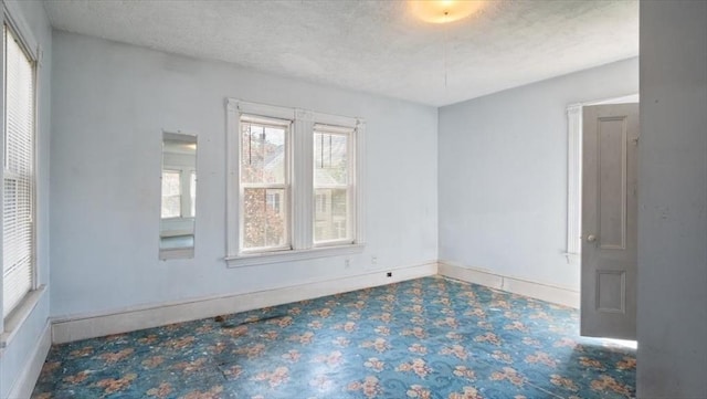 14 Maple St, Amesbury, MA 01913 - empty room featuring a textured ceiling and baseboards
