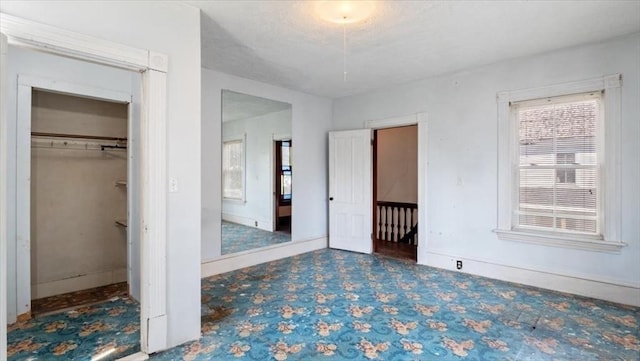14 Maple St, Amesbury, MA 01913 - unfurnished bedroom with baseboards and a walk in closet