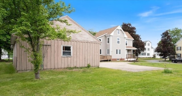 14 Maple St, Amesbury, MA 01913 - rear view of house featuring board and batten siding and a lawn