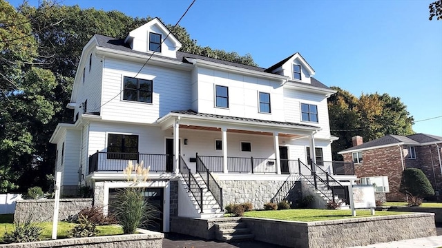 view of front of property with a porch and a garage