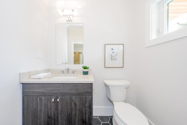 bathroom with tile patterned floors, vanity, and toilet