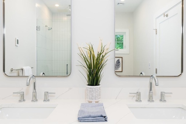 bathroom with vanity and a shower with shower door