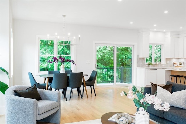 dining room featuring light hardwood / wood-style floors and a notable chandelier