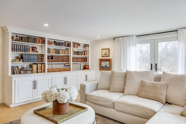 living room with french doors, light wood finished floors, and recessed lighting