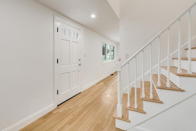 foyer with stairway, recessed lighting, light wood-style floors, and baseboards