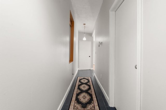 159 Cottage St Unit 6, Boston, MA 02128 - hallway with dark tile patterned flooring and baseboards