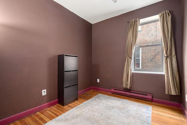 159 Cottage St Unit 6, Boston, MA 02128 - unfurnished room featuring a baseboard heating unit and wood finished floors