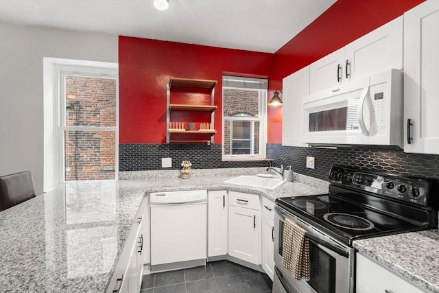 159 Cottage St Unit 6, Boston, MA 02128 - kitchen with white appliances, white cabinetry, and decorative backsplash