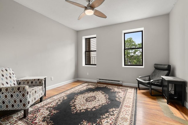 159 Cottage St Unit 6, Boston, MA 02128 - sitting room featuring a baseboard radiator, a ceiling fan, and light wood-type flooring