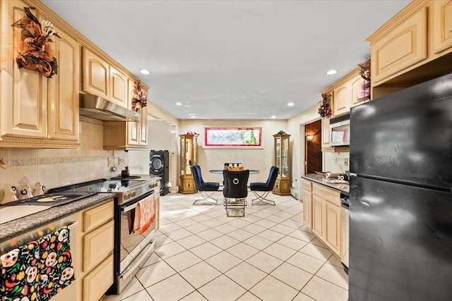 kitchen featuring appliances with stainless steel finishes, light brown cabinets, tasteful backsplash, and light tile patterned floors