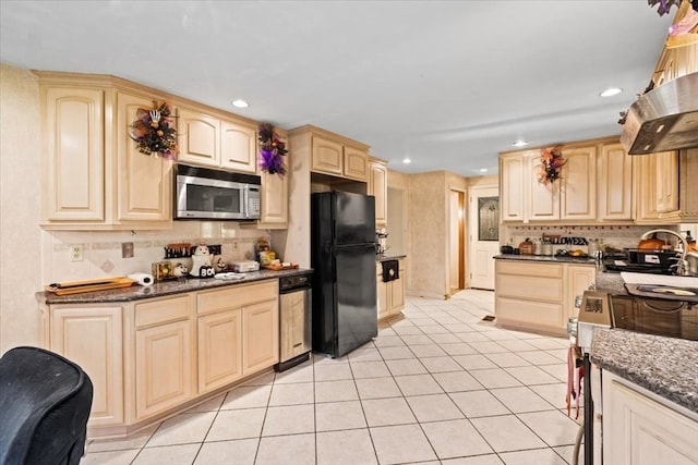 kitchen featuring light brown cabinetry, light tile patterned flooring, island range hood, stainless steel appliances, and dark stone counters