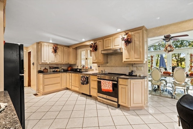 kitchen with light brown cabinets, stainless steel appliances, and light tile patterned floors