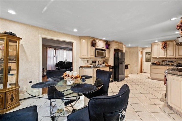 tiled dining area with a baseboard heating unit