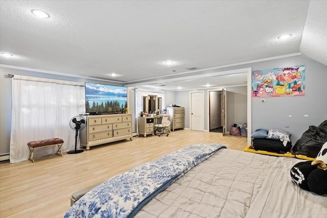 bedroom featuring lofted ceiling, wood-type flooring, and a textured ceiling