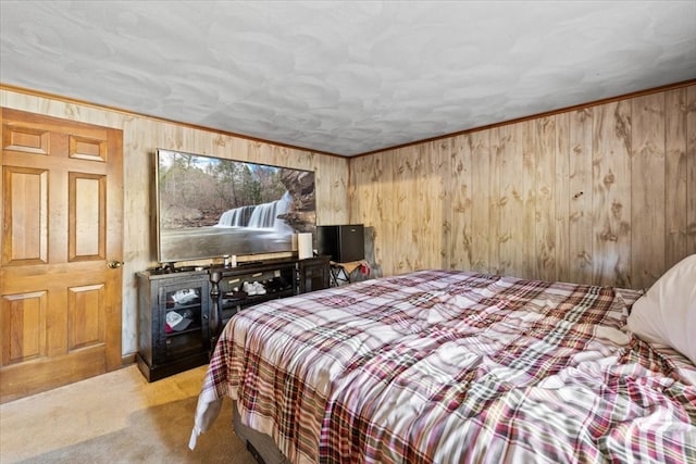 carpeted bedroom featuring ornamental molding and wood walls