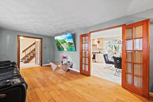 living room with french doors and light hardwood / wood-style flooring