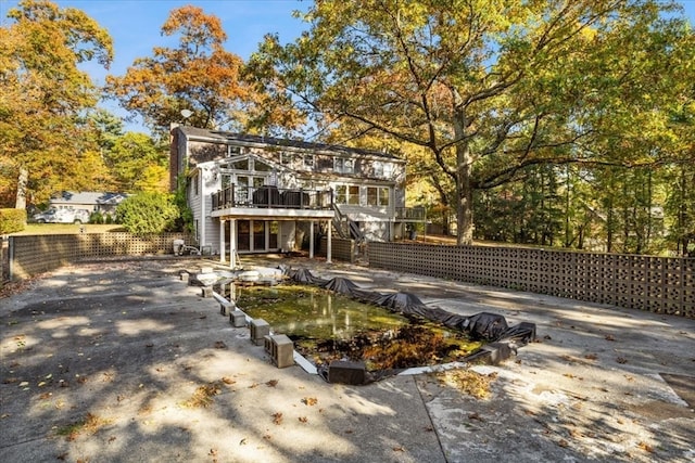 rear view of property featuring a deck