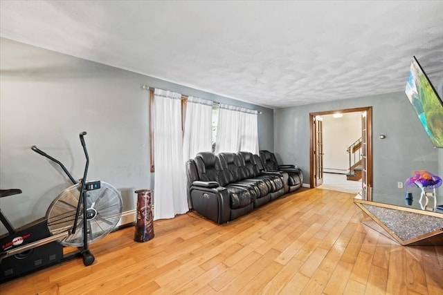 living room with baseboard heating and light wood-type flooring