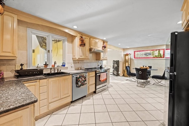 kitchen with light brown cabinets, tasteful backsplash, light tile patterned floors, appliances with stainless steel finishes, and sink