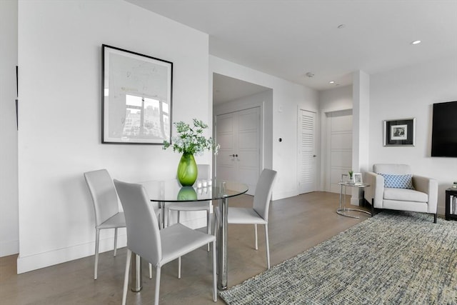 dining space featuring baseboards and recessed lighting