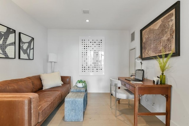 living room featuring light wood-style floors, a desk, baseboards, and recessed lighting